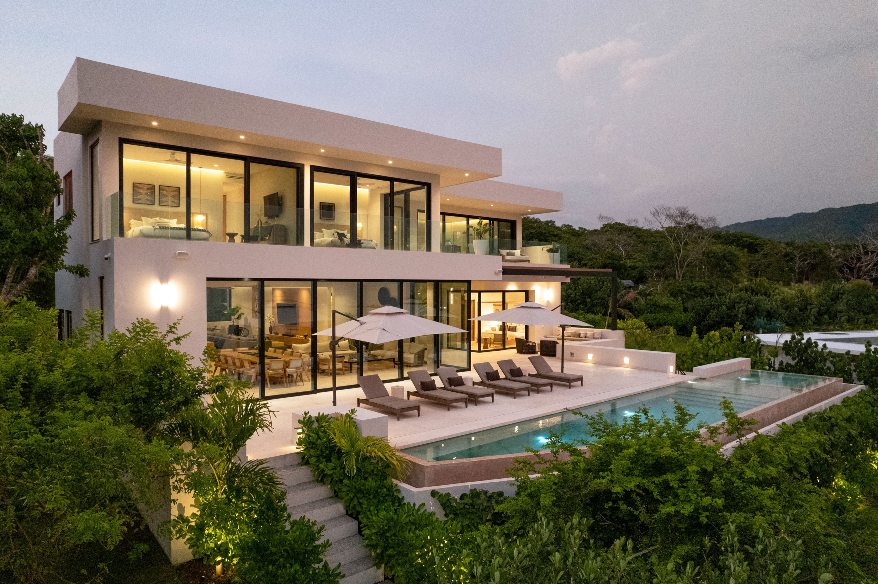 Casa Todos Juntos beachfront villa and pool at dusk
